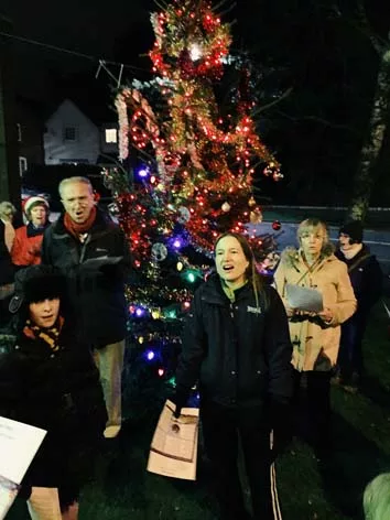 Singing round the Christmas tree in Evington